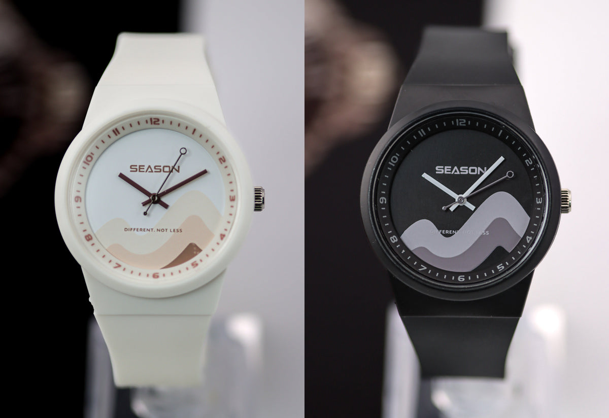 The free Autism Awareness watch included with every order, in white and black. Dial reads DIFFERENT. NOT LESS.